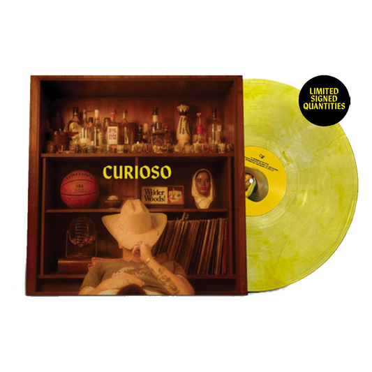 Limited edition signed yellow vinyl record for the album 'Curioso' by Wilder Woods, with a gatefold cover featuring an interior image of various objects and a photograph of the artist.